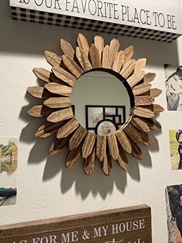 Sunflower-shaped wooden mirror on wall with decorative signs.