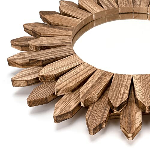 Wooden sunburst mirror with pointed edges.