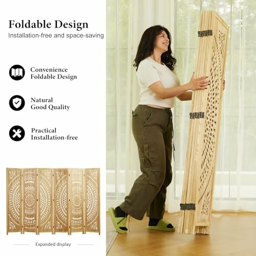 Woman folding a decorative wooden room divider.