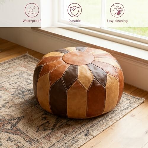 Round leather pouf on a patterned rug by a window, with icons indicating waterproof, durable, and easy cleaning.