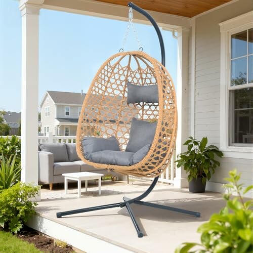Outdoor hanging chair with cushion on a porch, showcasing its stylish and comfortable design.