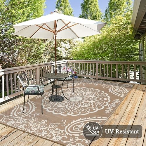 Outdoor patio with table, chairs, umbrella, and decorative rug on a wooden deck.